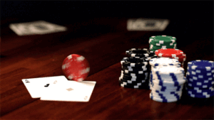 A poker player applying live poker strategy at a crowded casino table