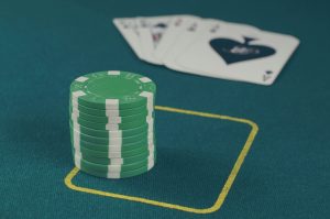 Beginner poker players learning at the table with chips
