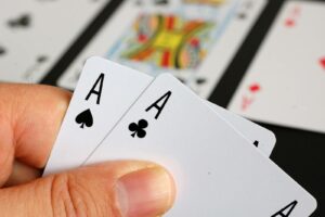 Advanced Tournament Play Close-up of a player holding Aces, representing strong hands in advanced poker tournament play.