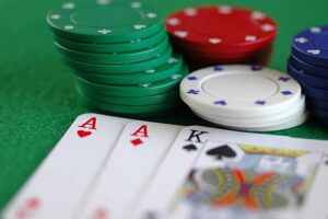 Bankroll Management Tips Poker player counting chips and managing bankroll at a felt table
