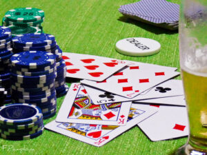 Beginner Poker Tips A beginner poker player studying cards and chips at a training session