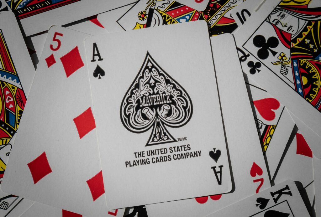 A pile of playing cards sitting on top of each other, symbolizing the game of Poker Psychology.