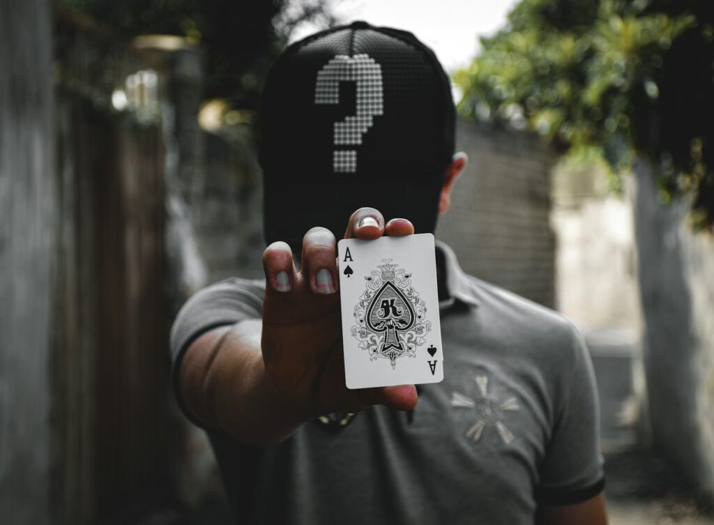 "POKER tips player holding an ace"